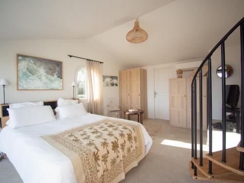 a bedroom with a white bed and a tv at Carqueiranne: Villa de Charme avec Piscine, Vue Mer, pour 8 Personnes - FR-1-599-119 in Carqueiranne
