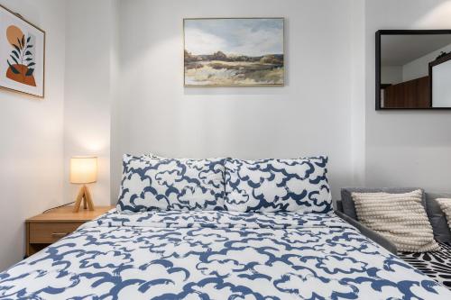 a bedroom with a bed with a blue and white comforter at Dominiks spacious classic family VIP 1 Bedroom Tambuli Balcony Pool Beach in Lapu Lapu City