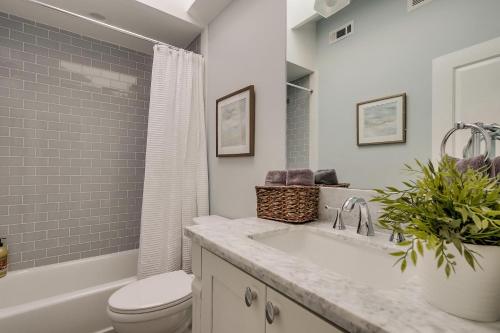 a bathroom with a sink and a toilet and a tub at Destination #41 in Fullerton