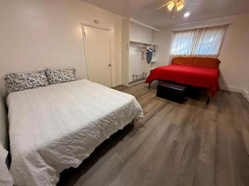 a bedroom with a white bed and a red blanket at Vegas Apt 8 Mins to The Strip - Free Parking in Las Vegas