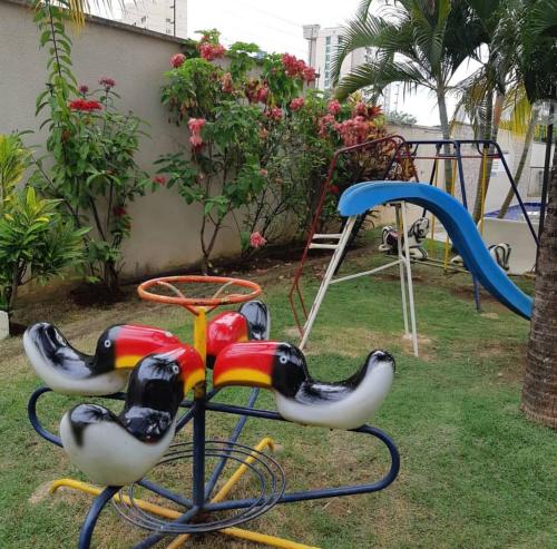 a childrens playground with a slide and a play park at Apartamento 2 Quartos Caldas Novas in Caldas Novas