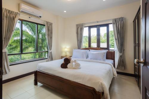 a bedroom with a bed with two towels on it at First Ao Nang Private Pool Villa in Ao Nang Beach