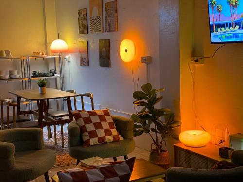 a living room with a table and a dining room at Isle Be Back Catanduanes Staycation - Cavinitan in Virac