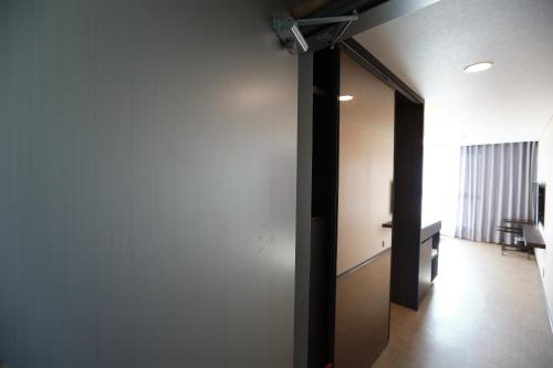a hallway with a door leading to a room at Jeju Stay in Sungsan in Seogwipo