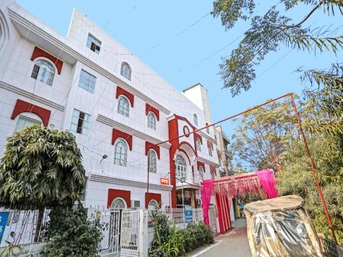 a large white building with red accents at Hotel O Raas Near Hira Sweet in New Delhi