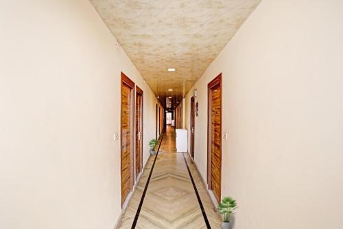a corridor of a building with white walls and a ceiling at Hotel O Raas Near Hira Sweet in New Delhi