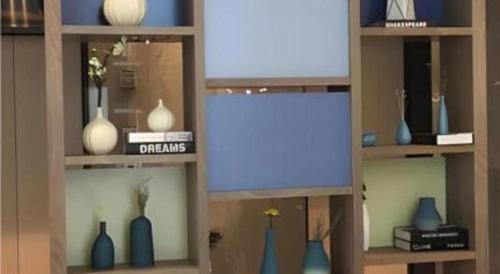 a shelf with blue and white vases on it at City Comfort Inn Hefei Railway Station Metro Station in Hefei