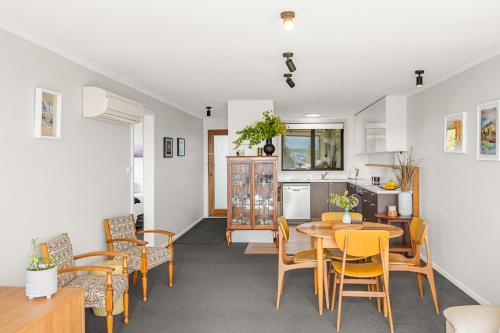 a kitchen and dining room with a table and chairs at 4onFour in Hobart