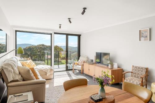 a living room with a couch and a table at 4onFour in Hobart