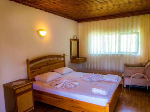 a bedroom with a bed with two pillows on it at Dalyan Pension in Dalyan