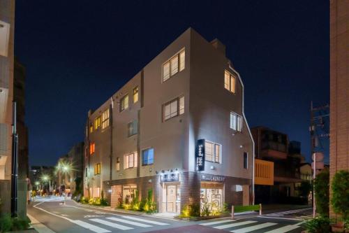 a large building on a city street at night at Seed INN Haneda Terrace 101 in Tokyo