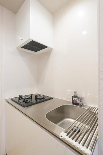 a kitchen with a sink and a stove at Seed INN Haneda Terrace 101 in Tokyo
