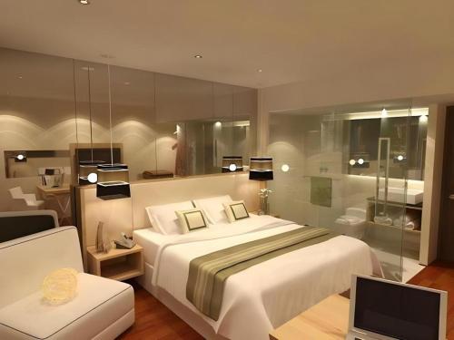 a bedroom with a bed and a desk with a television at Horison Ultima Semarang in Jomblang