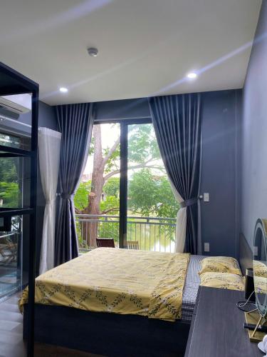 a bedroom with a bed and a large window at Dory Homestay in Hue