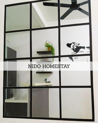 a glass wall with a ceiling fan and a mirror at Home at Port Dickson in Port Dickson