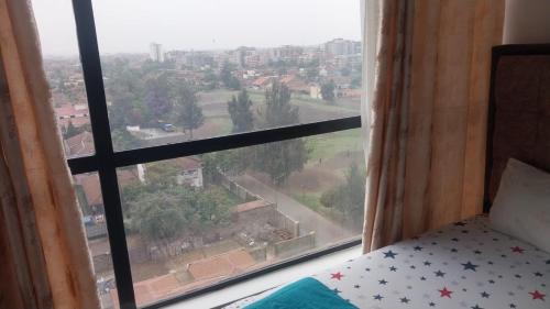 Ένα ή περισσότερα κρεβάτια σε δωμάτιο στο Amazing StaysBnB near JKIA