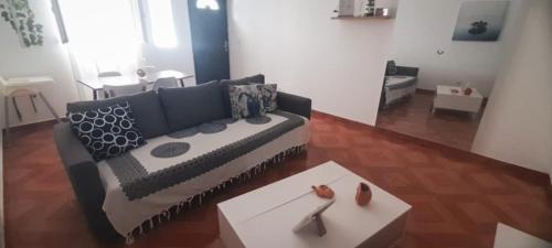 a living room with a couch and a table at Tarrafal snuggle in Tarrafal