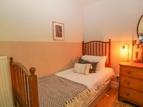 Un dormitorio pequeño con una cama y una cómoda. en The Coach House - Holmwood, en Glasgow
