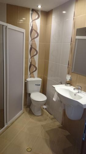a bathroom with a toilet and a sink at Yagnevo Complex in Yagnevo