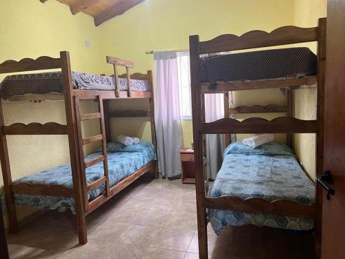 a room with three bunk beds in a room at cabañas elita in San Rafael