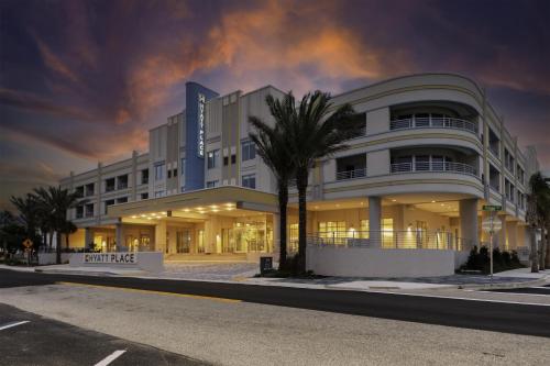 a building with a palm tree in front of it at Hyatt Place St Augustine Vilano Beach in St. Augustine