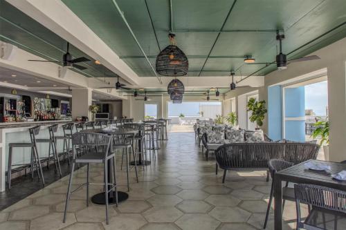 a bar with chairs and tables in a restaurant at Hyatt Place St Augustine Vilano Beach in St. Augustine