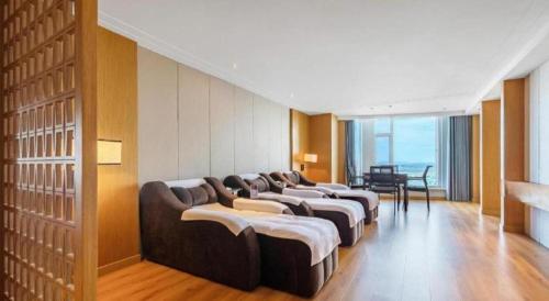 a row of couches lined up in a room at Dandong Xin An Dong Hotel in Dandong