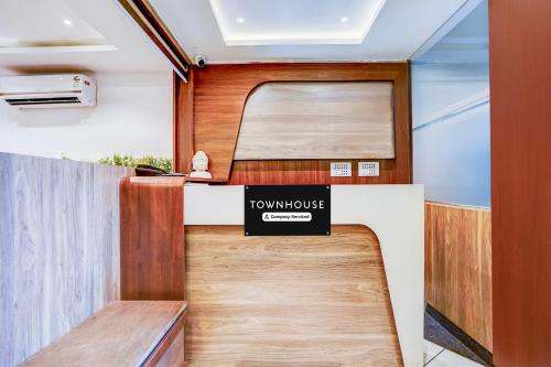 a front desk of a town house with a sign on it at Super Townhouse Zero Mile Gandhi Setu Formerly Classic Court in Gulzārbāgh