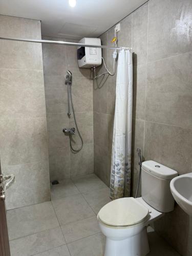 a bathroom with a shower and a toilet and a sink at Luxury 2BR Sea View by Superstay in Batam Center