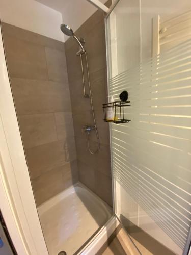 a bathroom with a shower with a glass door at Studio indépendant avec terrasse dans propriété campagne Aixoise in Aix-en-Provence