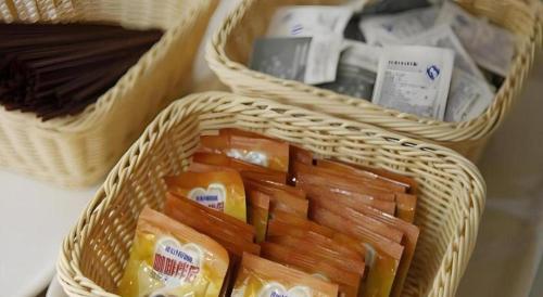 two baskets filled with carrots and other food items at Beijing Yi Jia Hotel in Beijing