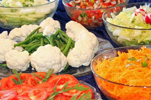 a bunch of vegetables in bowls on a table at Panoramahotel Obkircher in Nova Ponente