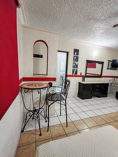 a living room with a table and a mirror at Loma Bonita - Hotel Zapopan in Guadalajara