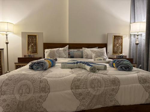 a bedroom with two large beds with pillows on them at Sea-View 1BR in Saadiyat - Pool - GYM - Free Parking in Abu Dhabi