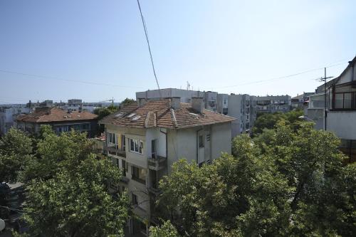 a building with a tile roof in a city at Poshta 1 Apartment 3 in Varna City