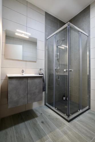 a bathroom with a shower and a sink at St Paul's Apt Distant SeaViews in St. Paul's Bay