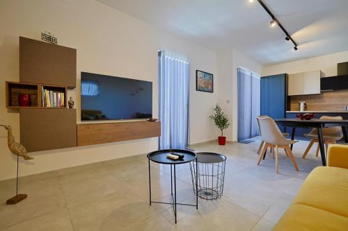 a living room with a couch and a table at St Paul's Apt Distant SeaViews in St. Paul's Bay