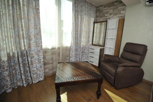 a living room with a chair and a table at Poshta 1 Apartment 3 in Varna City