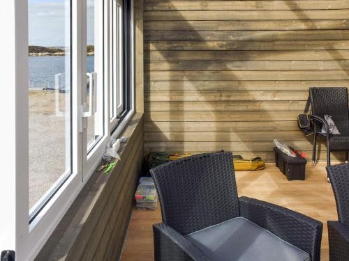 a porch with two chairs and two windows at 6 person holiday home in Dyrvik in Dyrvik