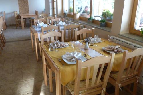 a dining room with a table with yellow table cloth at Guest House Eco Vila Mila in Rogaška Slatina