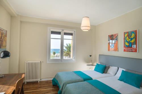 um quarto com 2 camas e uma janela em La Terrace - IB. Apartments em San Sebastián