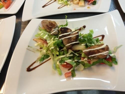 a plate of food with a salad on a table at Hotel Restaurant Cafe Houben in Nunhem