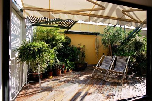 a patio with two chairs and a lot of plants at Loft de Cannes B&B in Cannes
