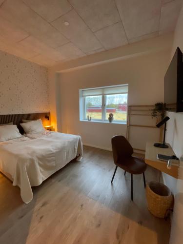 a bedroom with a bed and a desk and a window at Beauty sleep Guldager in Esbjerg