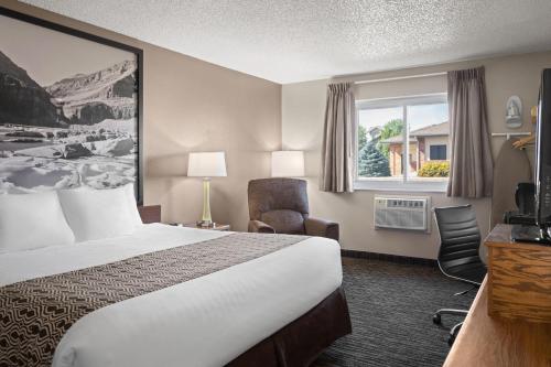 a hotel room with a bed and a window at Super 8 by Wyndham Lewistown in Lewistown