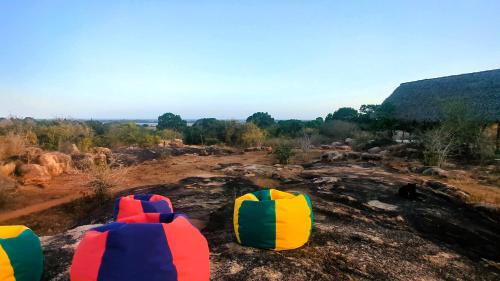 a group of colorful chairs sitting on top of a hill at Enchanted Escapes Yala in Kirinda