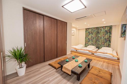 a room with two beds and a table at KTV Party House 3min to Itabashi Station Traditional Street Stay in Tokyo