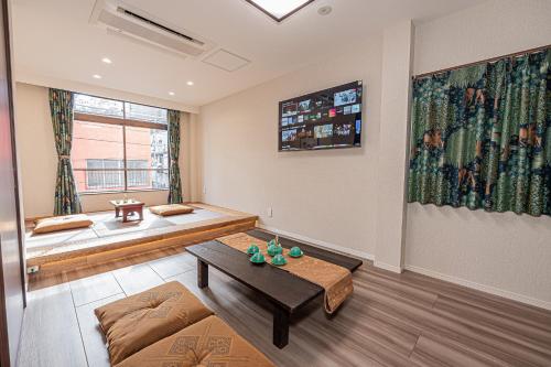 a living room with a couch and a table at KTV Party House 3min to Itabashi Station Traditional Street Stay in Tokyo