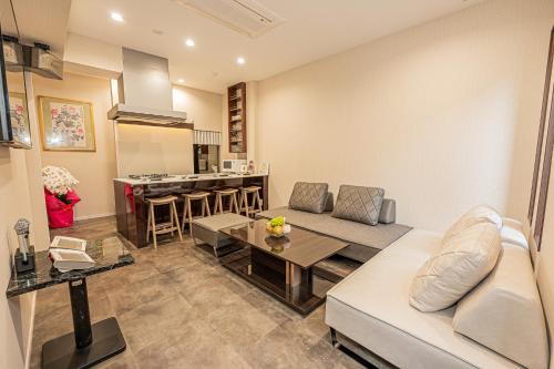 a living room with a couch and a table at KTV Party House 3min to Itabashi Station Traditional Street Stay in Tokyo