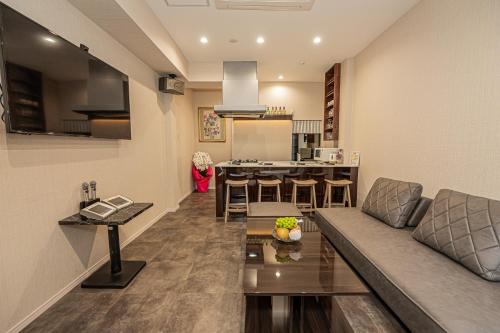a living room and kitchen with a couch and a table at KTV Party House 3min to Itabashi Station Traditional Street Stay in Tokyo